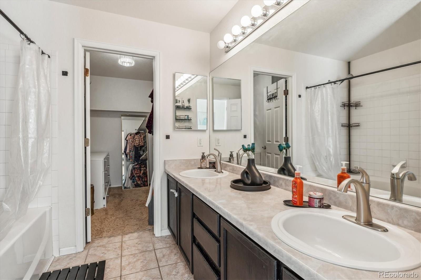 1345 Trail Ridge Road Longmont, CO 80504 - Photo 14 of 25 a bathroom with a sink double vanity and a mirror