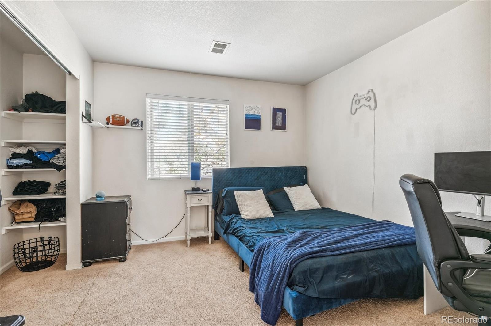 1345 Trail Ridge Road Longmont, CO 80504 - Photo 15 of 25 a bedroom with a bed a table and chair
