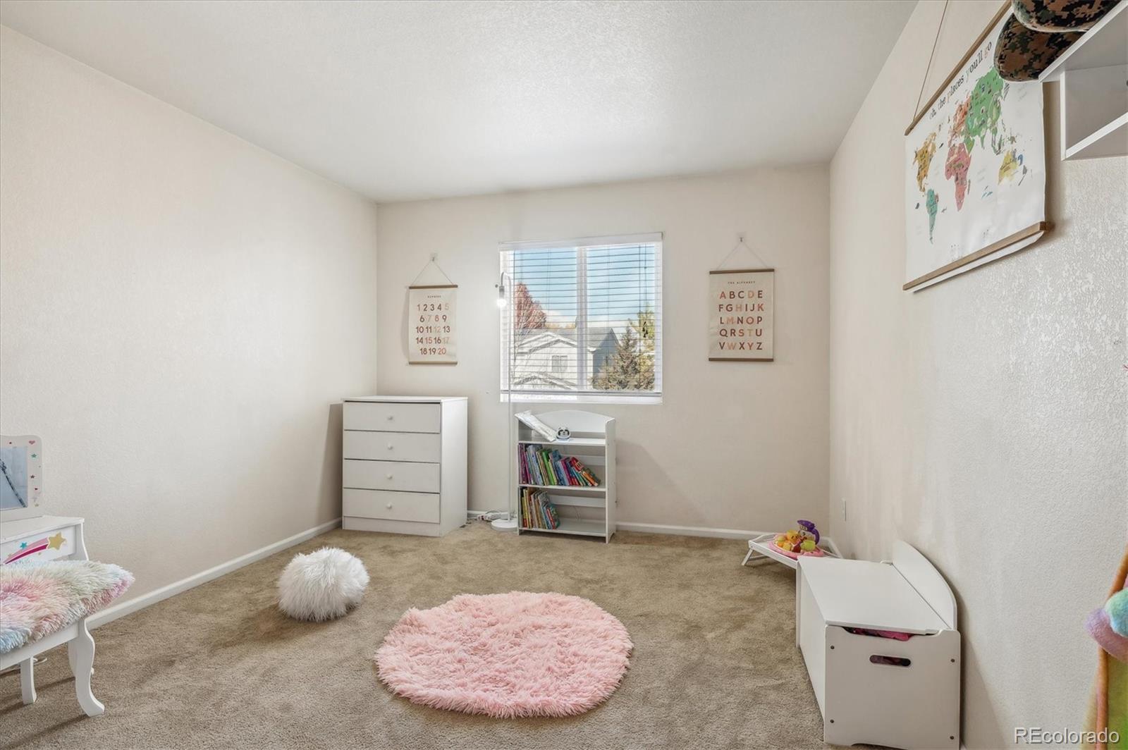 1345 Trail Ridge Road Longmont, CO 80504 - Photo 19 of 25 a bedroom with a bed and a cabinets