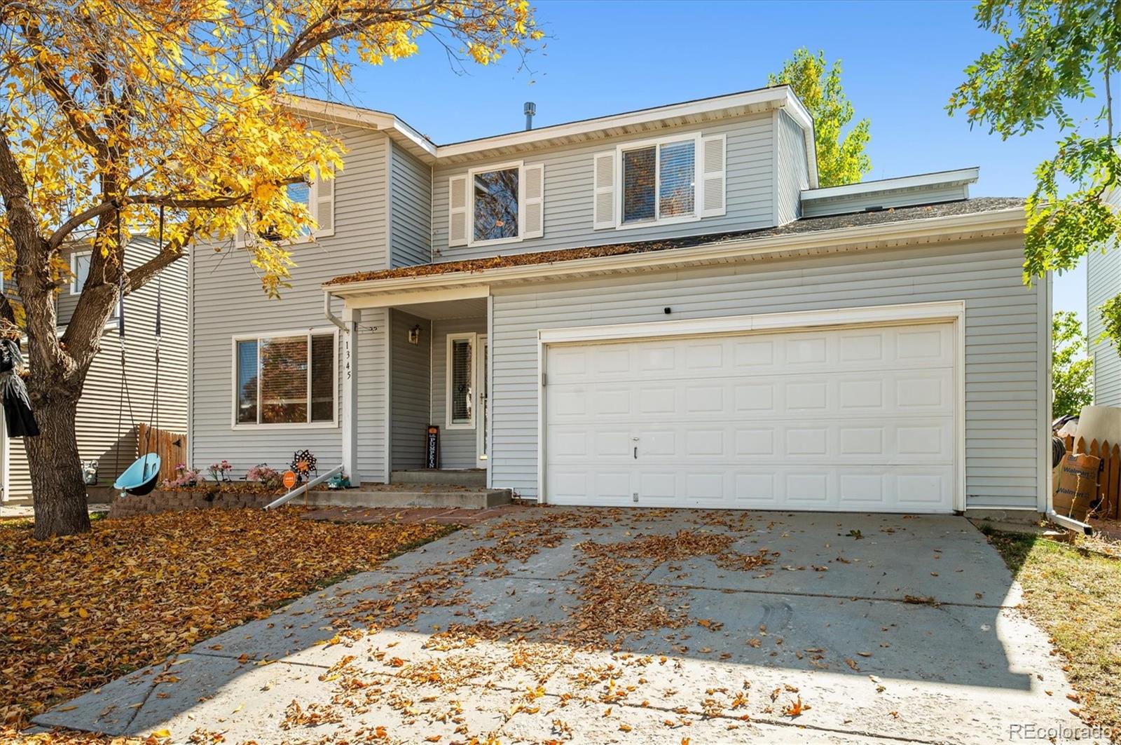 1345 Trail Ridge Road Longmont, CO 80504 - Photo 2 of 25 a front view of a house with a yard
