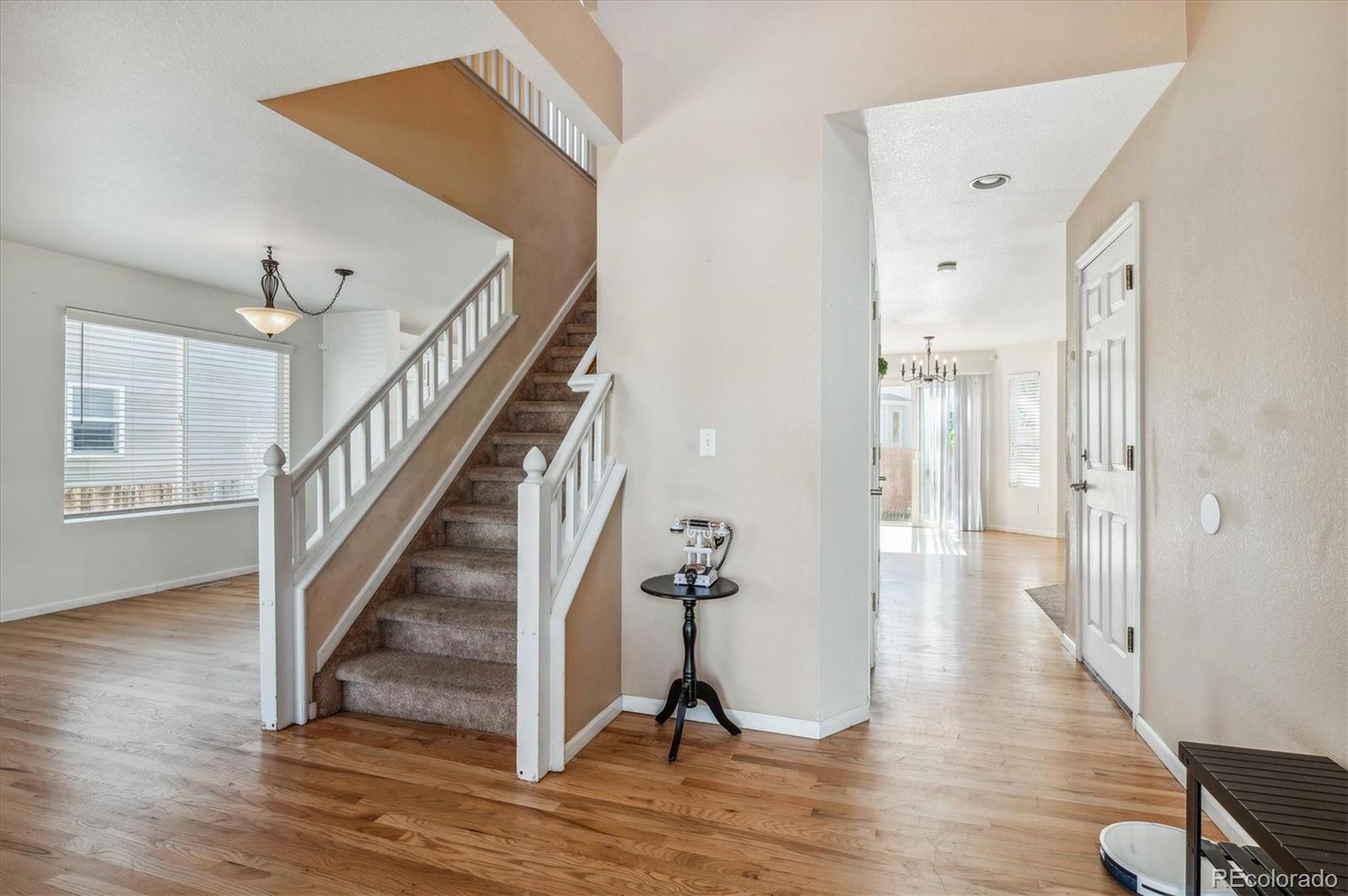 1345 Trail Ridge Road Longmont, CO 80504 - Photo 3 of 25 a view of a hallway with wooden floor and staircase