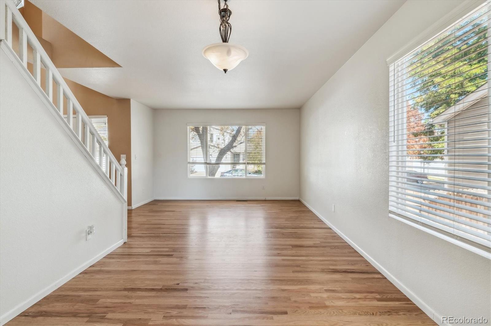 1345 Trail Ridge Road Longmont, CO 80504 - Photo 5 of 25 a view of an empty room with wooden floor and a window