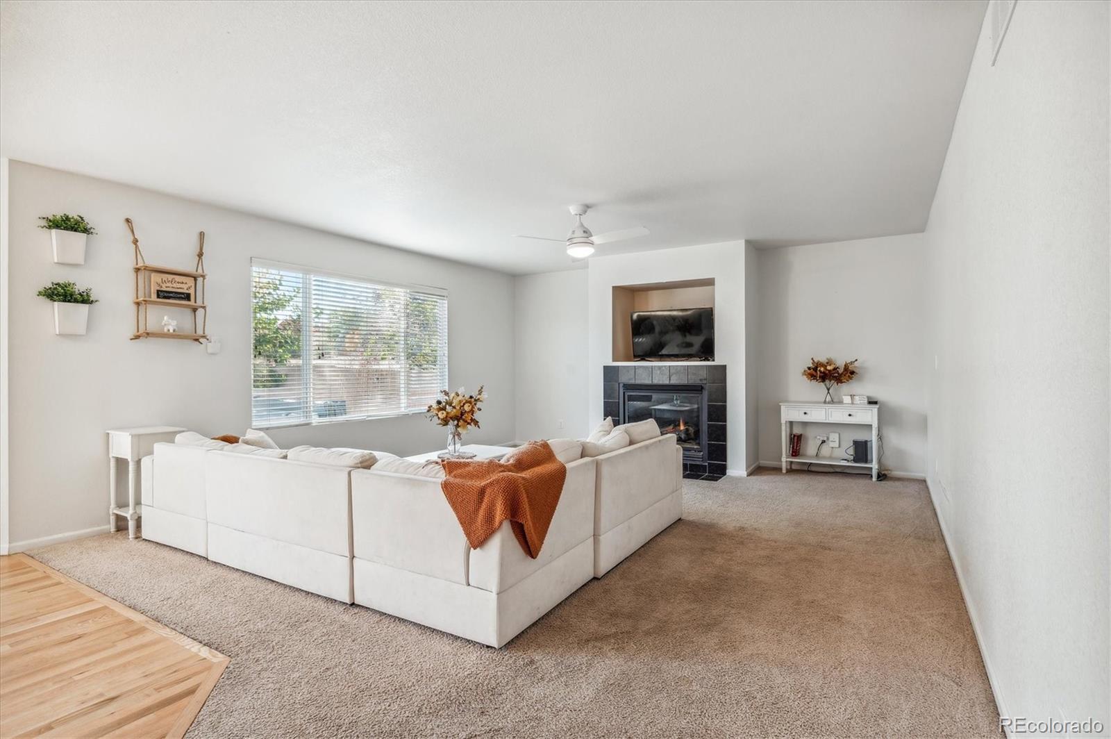 1345 Trail Ridge Road Longmont, CO 80504 - Photo 9 of 25 a living room with furniture a flat screen tv and a fireplace