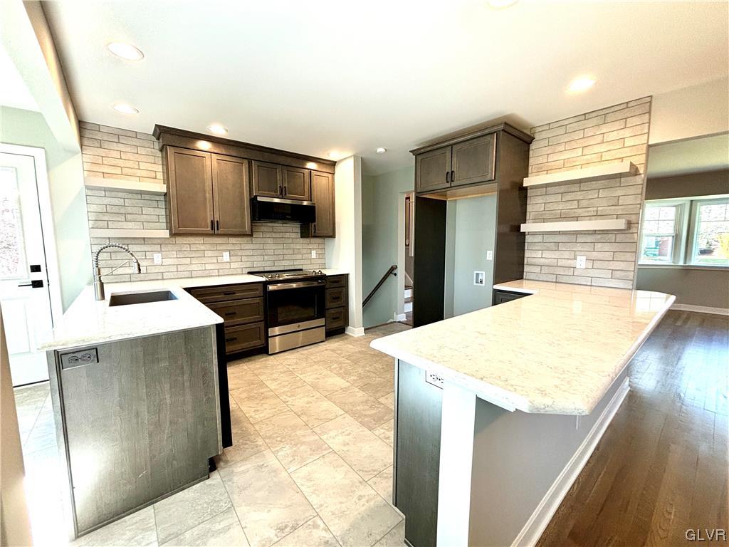 3172 Shakespeare Road Bethlehem, PA 18017 - Photo 6 of 19 a kitchen with stainless steel appliances kitchen island granite countertop a sink and a stove