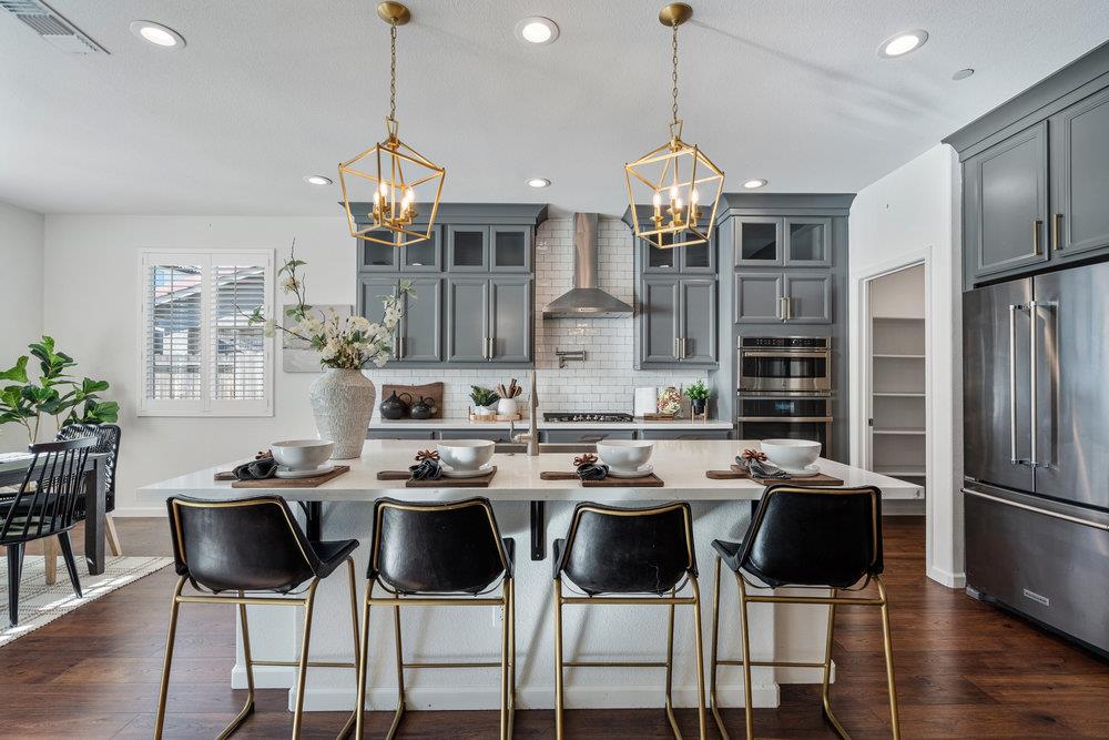 20 Hospital Road Hollister, CA 95023 - Photo 14 of 46 a kitchen with stainless steel appliances a dining table chairs and granite counter tops
