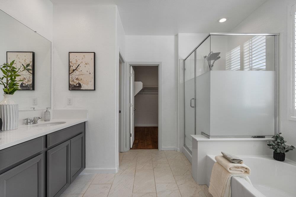 20 Hospital Road Hollister, CA 95023 - Photo 26 of 46 a bathroom with a bathtub a sink and a mirror