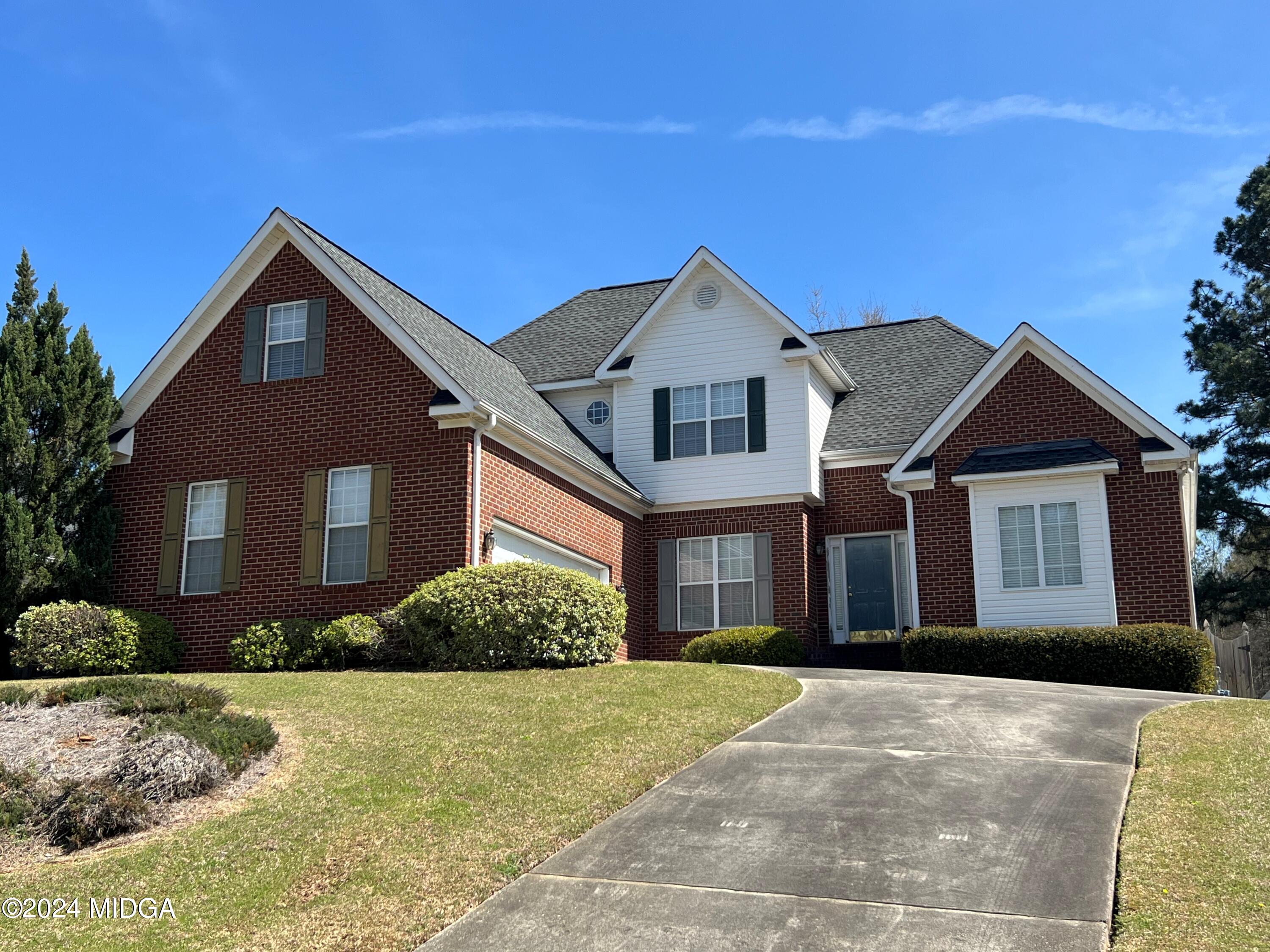 a front view of a house with a yard