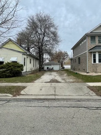 a view of white house with a yard