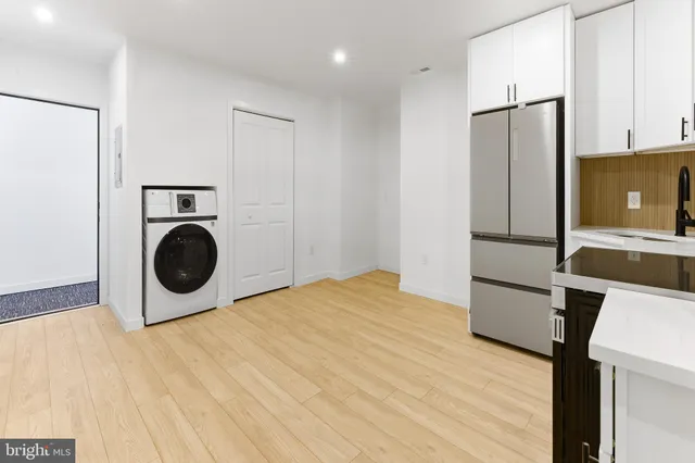 a kitchen with stainless steel appliances a stove top oven microwave and cabinets