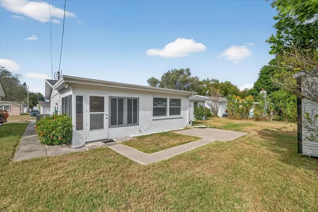 a view of house with yard and entertaining space