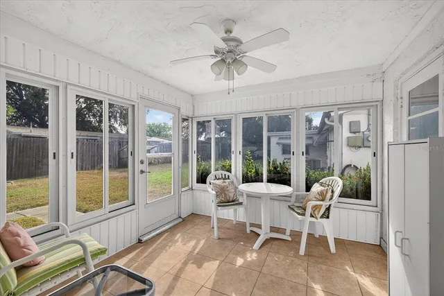 a living room with furniture and large windows