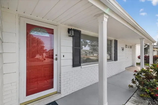 a view of a hallway with wooden floor and a living room