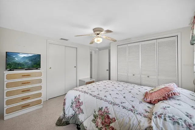 a bedroom with two beds and a chandelier