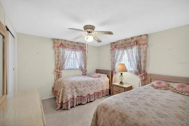 a bedroom with two beds and a chandelier