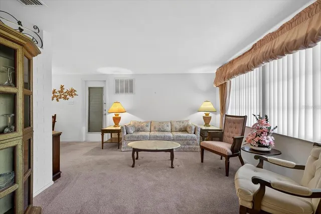 a kitchen with a dining table chairs a sink dishwasher and cabinets