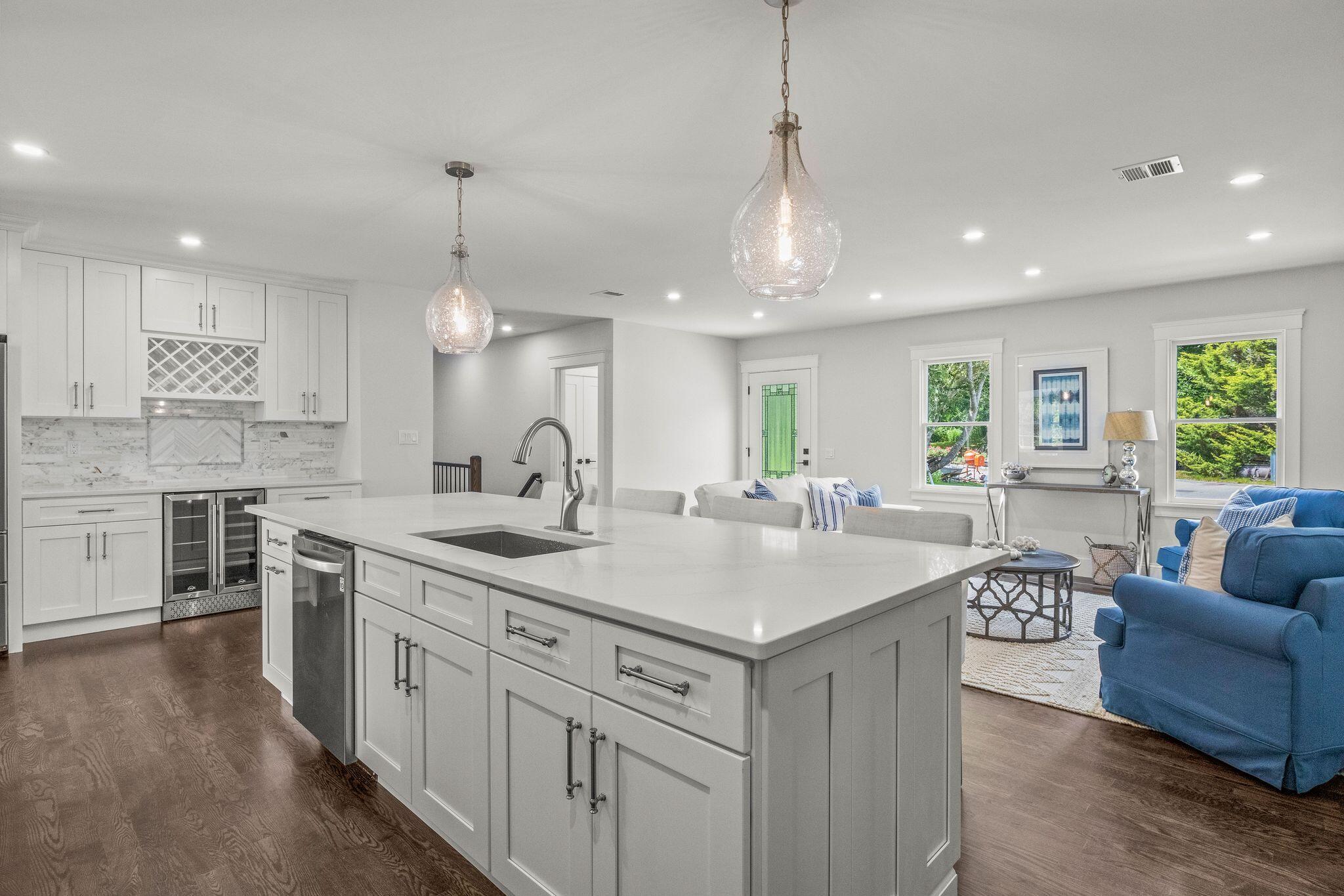 5 Locust Grove Road Harwich, MA 02645 - Photo 14 of 39 a kitchen with kitchen island granite countertop a stove a sink a center island a dining table and chairs