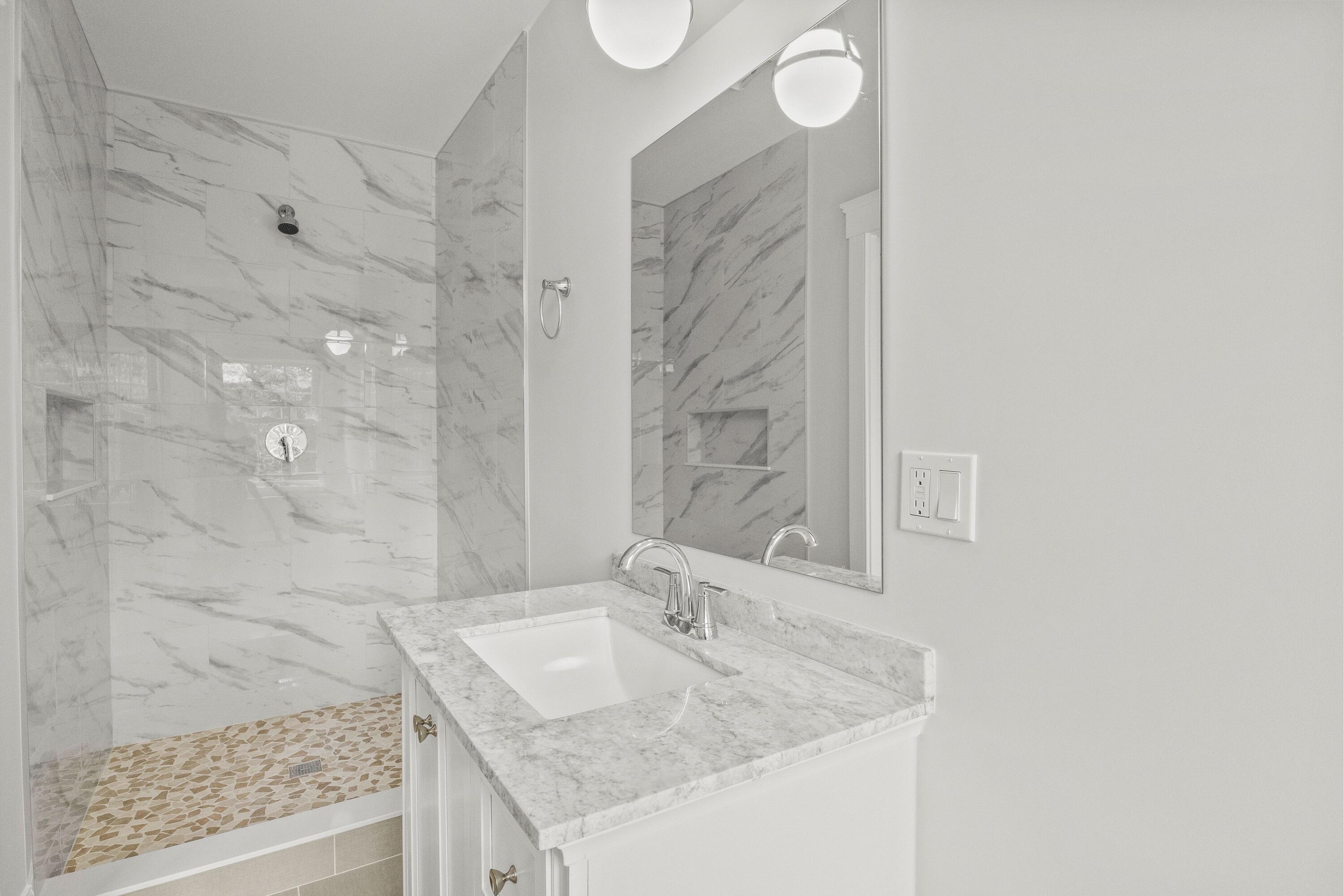 5 Locust Grove Road Harwich, MA 02645 - Photo 26 of 39 a bathroom with a granite countertop sink a mirror and a shower