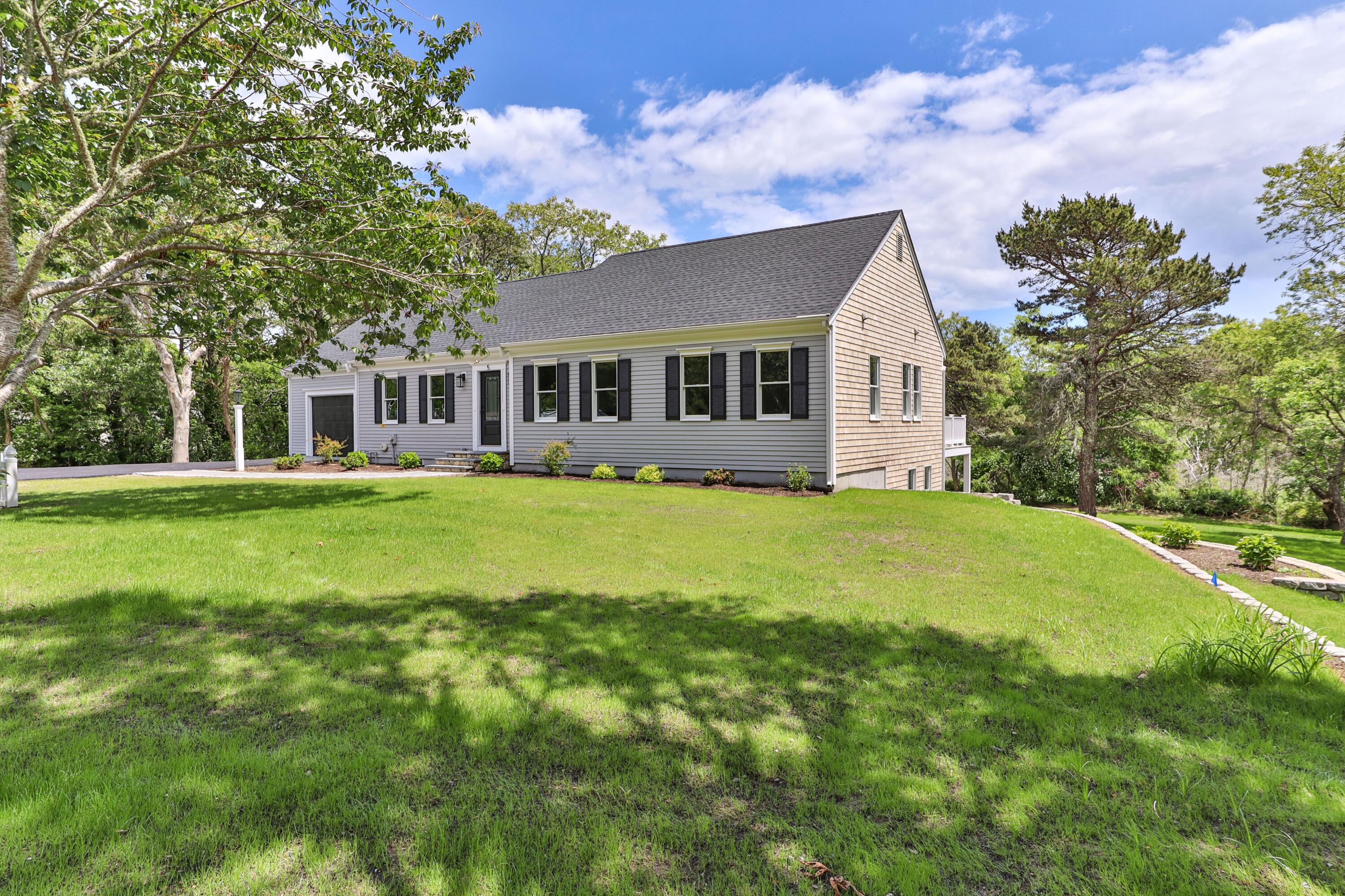 5 Locust Grove Road Harwich, MA 02645 - Photo 3 of 39 a front view of house with yard and trees around