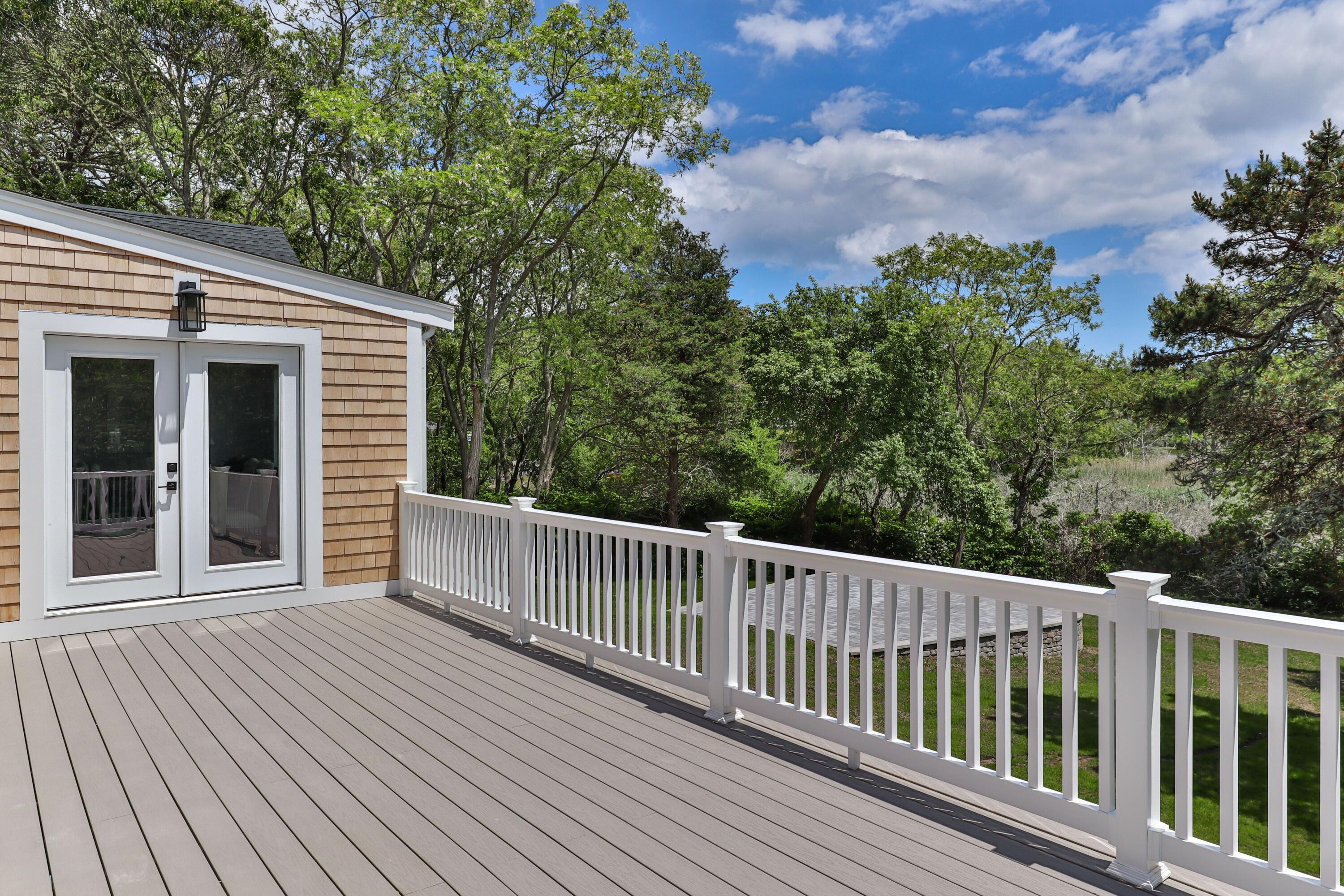5 Locust Grove Road Harwich, MA 02645 - Photo 9 of 39 a view of a wooden roof deck