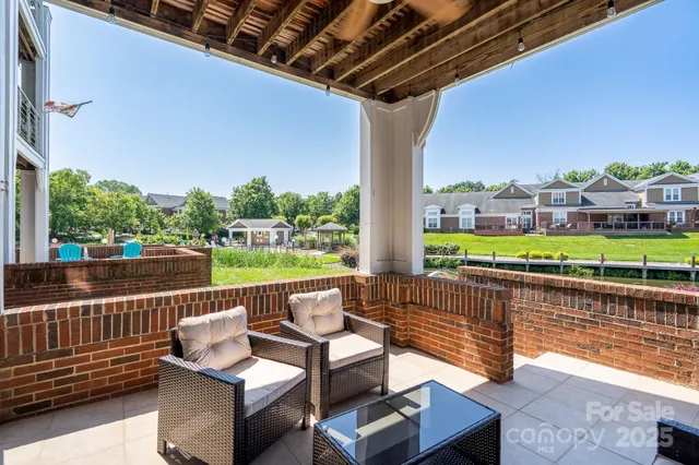 a view of swimming pool with couch and chairs