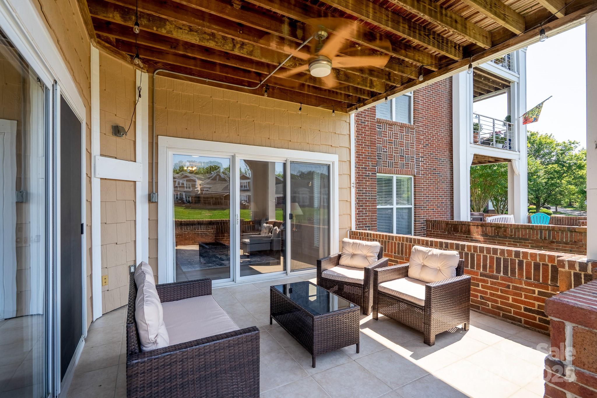 18511 Harborside Drive Cornelius, NC 28031 - Photo 12 of 27 a outdoor space with patio the couches and a dining table with large glass windows