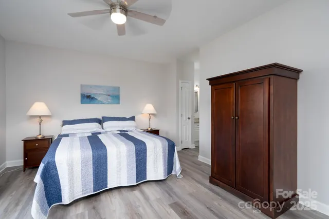 a bedroom with a bed and a lamp