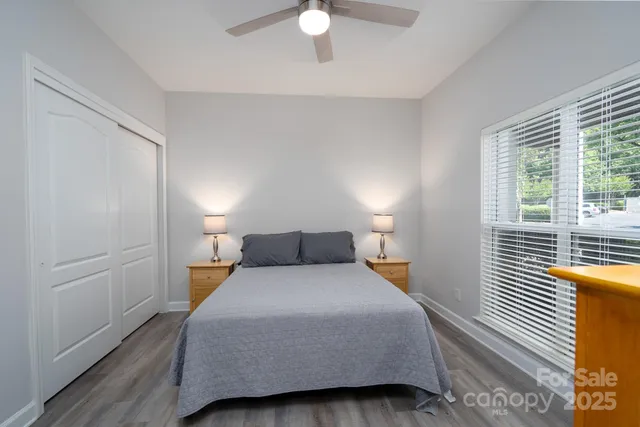 a bedroom with a bed and a large window