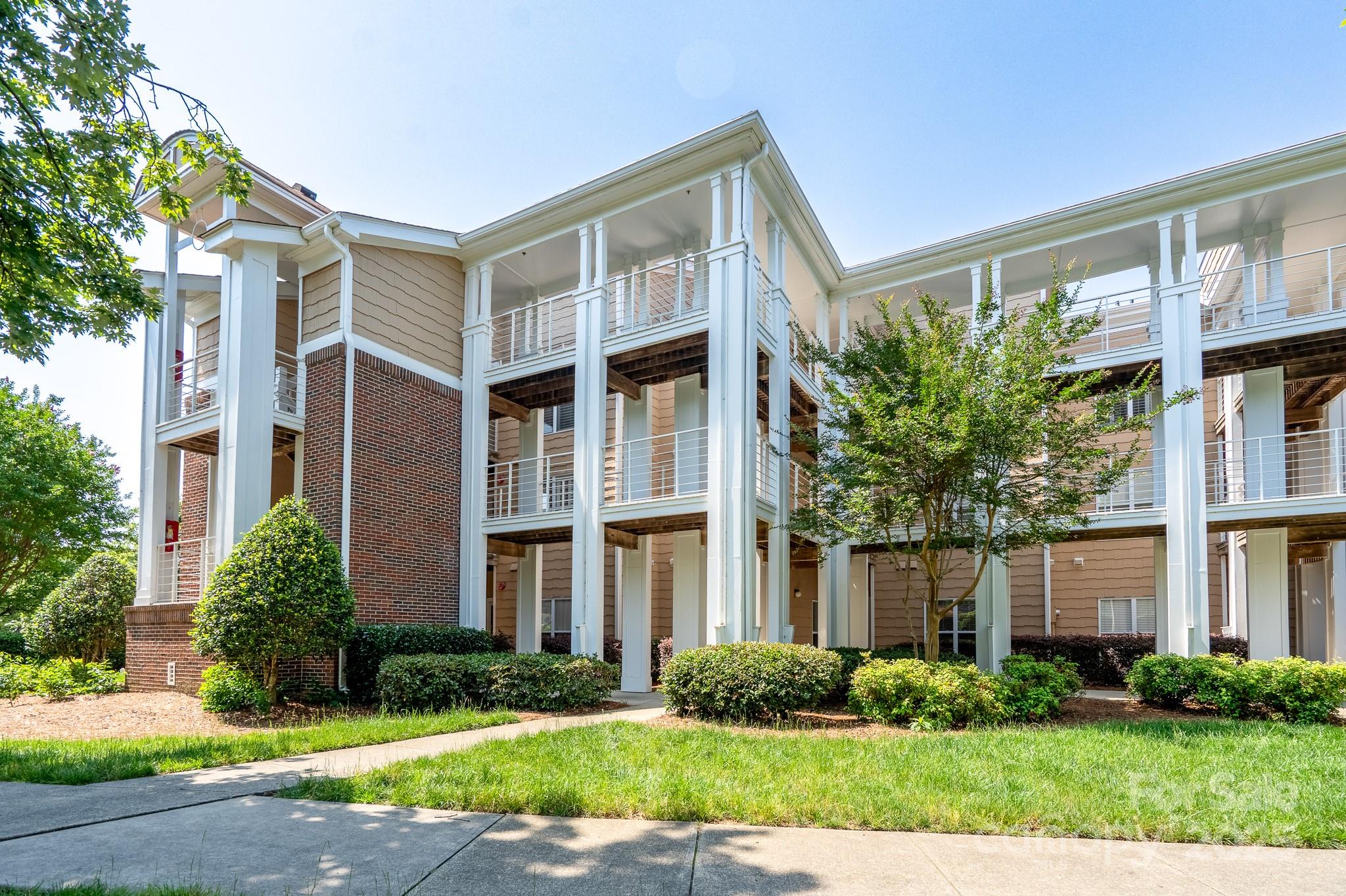 18511 Harborside Drive Cornelius, NC 28031 - Photo 22 of 27 a front view of a house with garden and plants