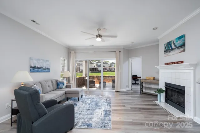 a living room with furniture large window and a fireplace