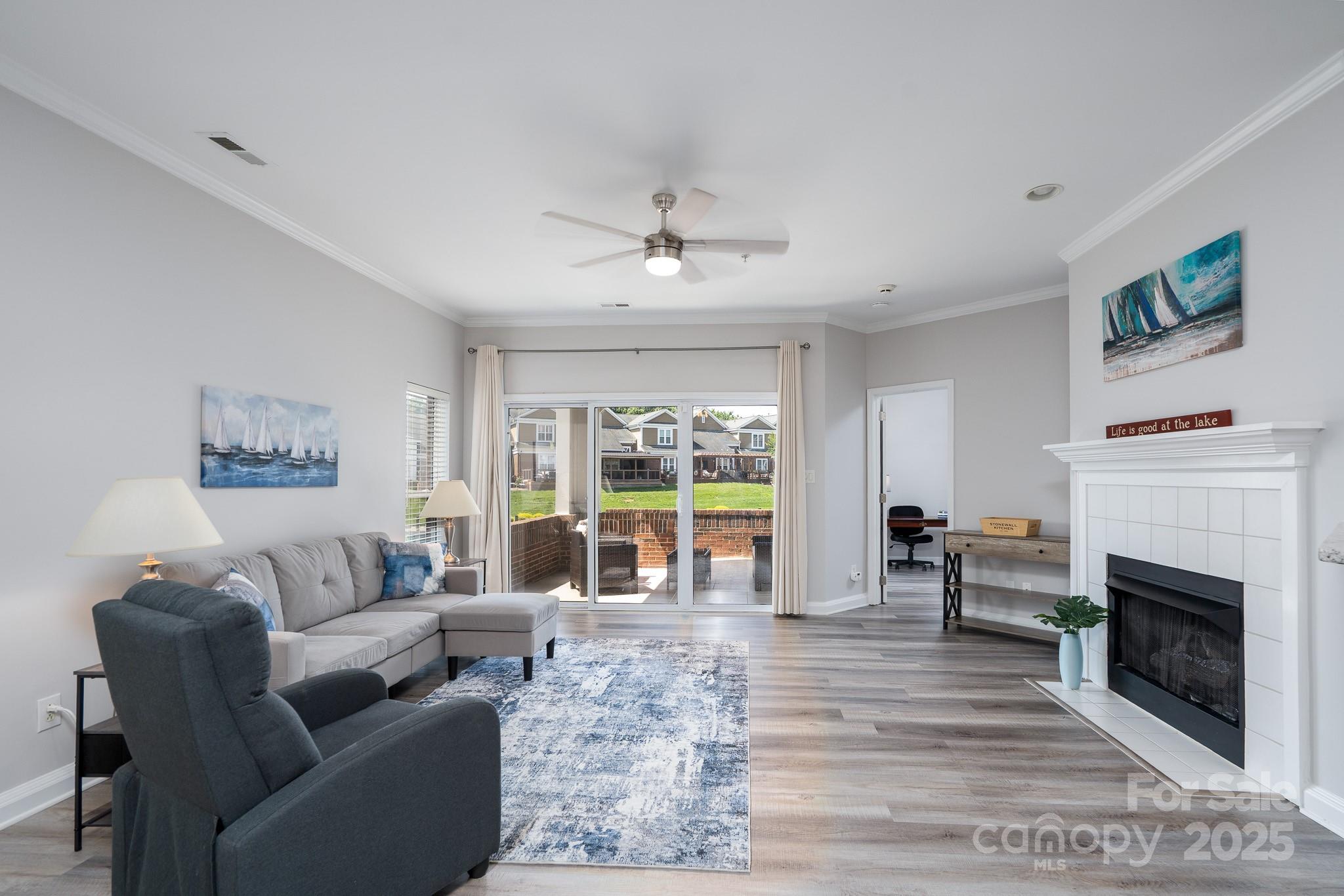 18511 Harborside Drive Cornelius, NC 28031 - Photo 4 of 27 a living room with furniture large window and a fireplace