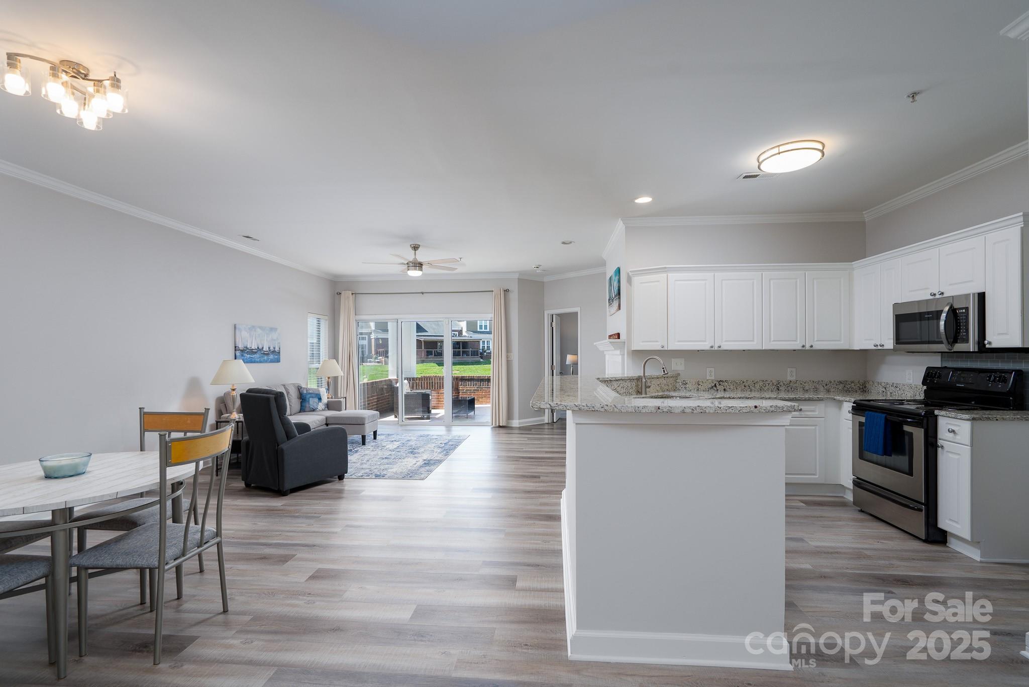 18511 Harborside Drive Cornelius, NC 28031 - Photo 6 of 27 a living room with stainless steel appliances granite countertop furniture wooden floor and a kitchen view