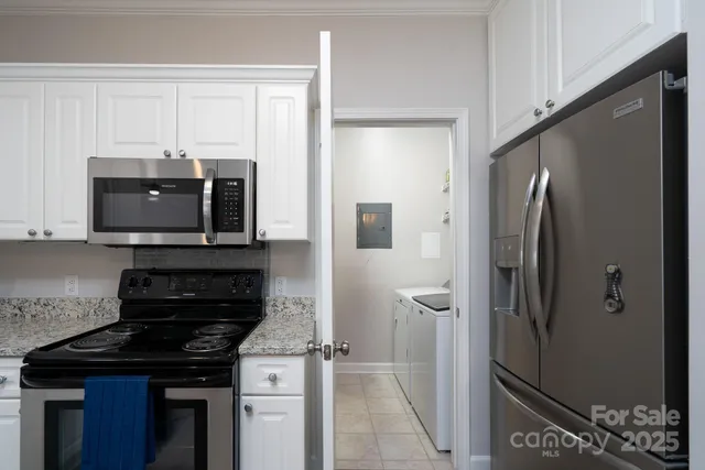 a kitchen with stainless steel appliances granite countertop a refrigerator and a stove top oven