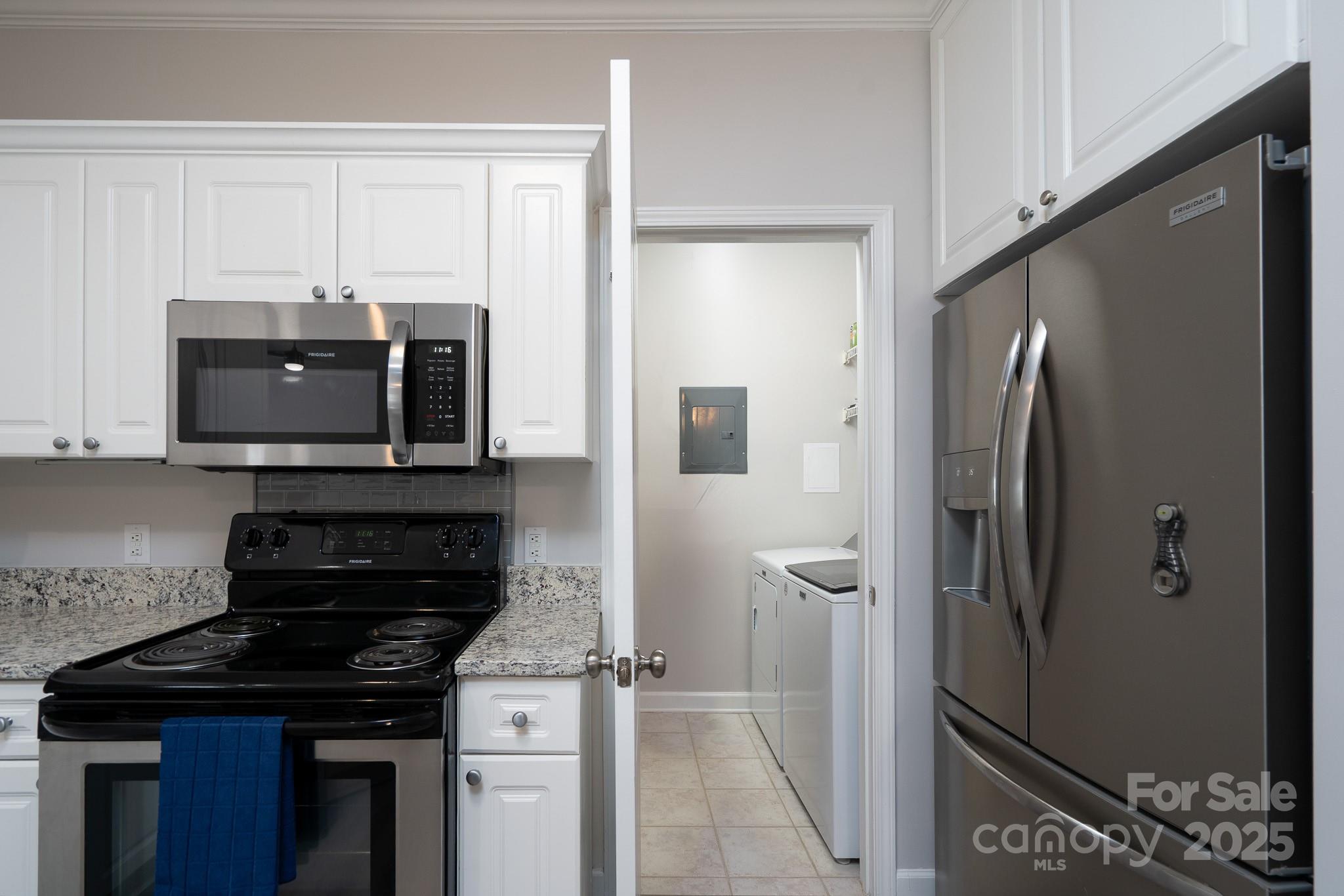 18511 Harborside Drive Cornelius, NC 28031 - Photo 9 of 27 a kitchen with stainless steel appliances granite countertop a refrigerator and a stove top oven