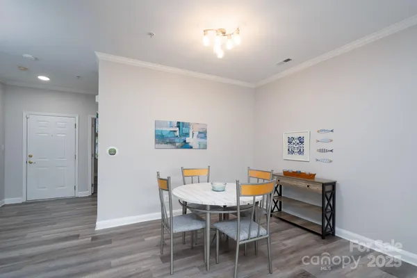 a dining room with a wooden table and chairs