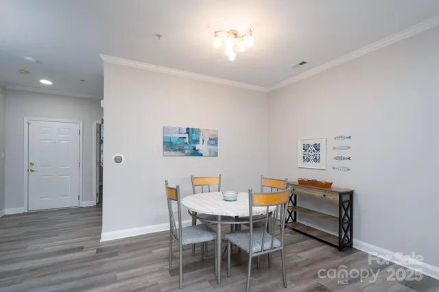 a dining room with a wooden table and chairs