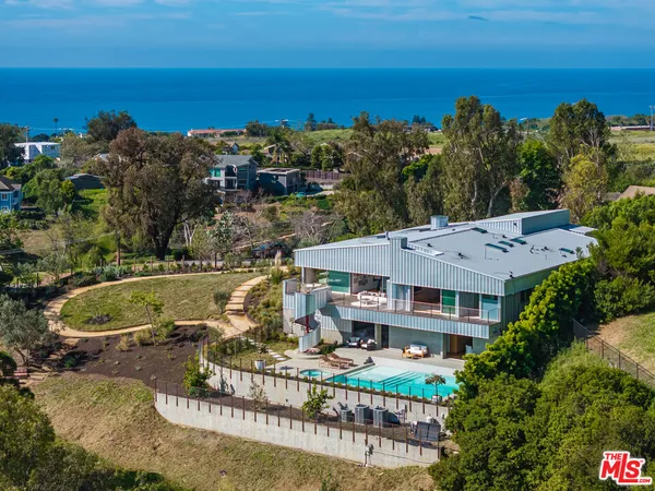 aerial view of a house with a ocean view