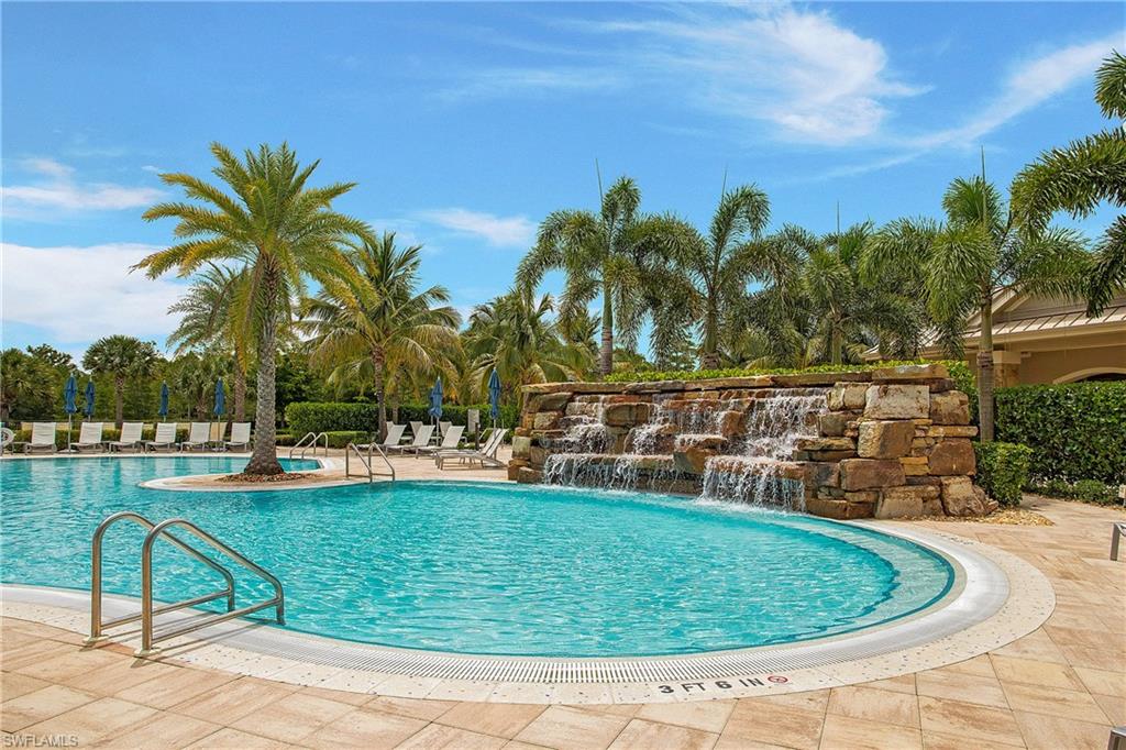 7674 Jacaranda Lane Naples, FL 34114 - Photo 35 of 45 a view of a swimming pool with a lounge chair