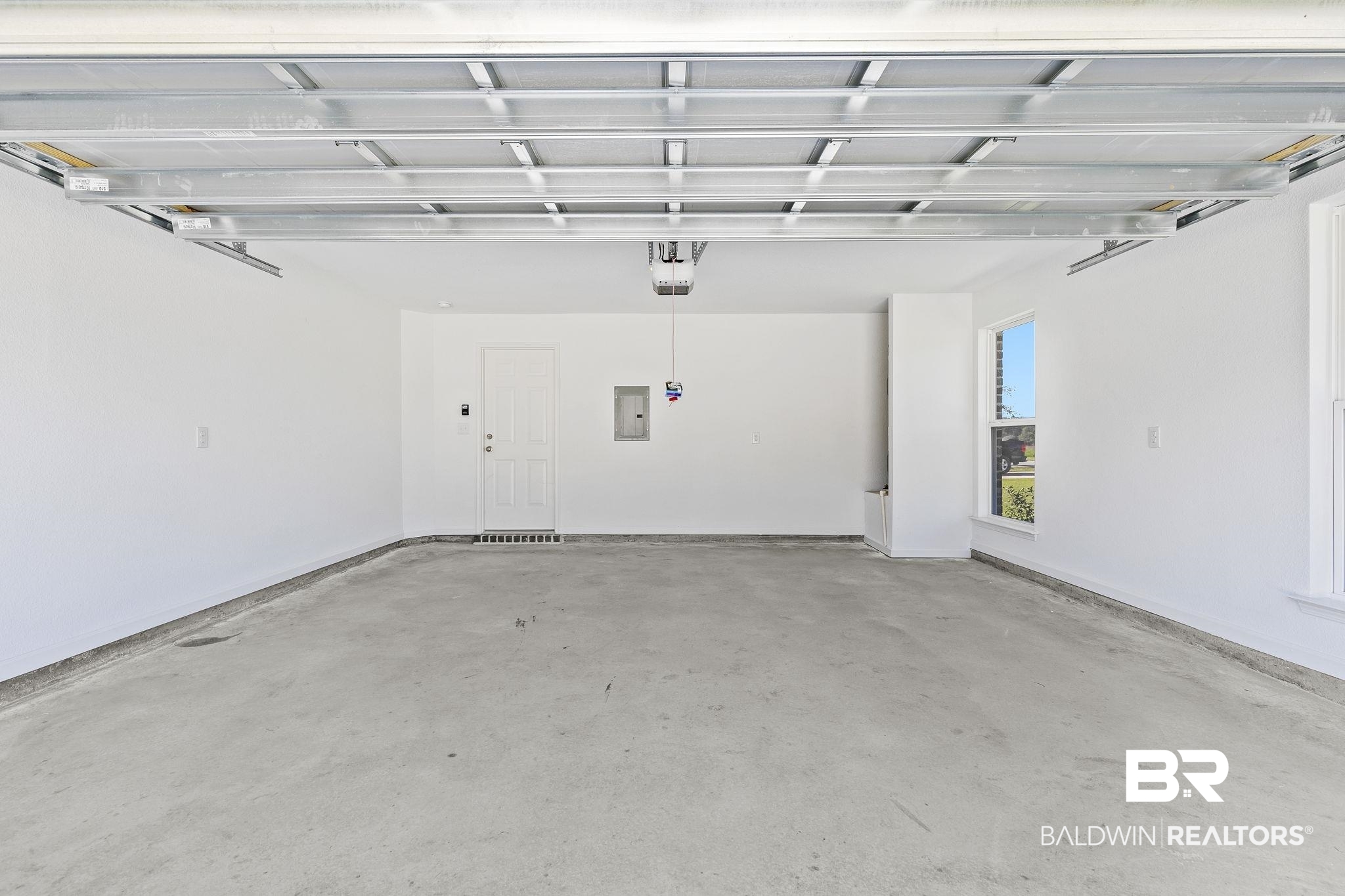 16014 Alabama Avenue Silverhill, AL 36576 - Photo 36 of 50 Garage featuring a garage door opener and electric panel