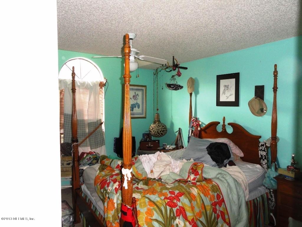1643 Derringer Road Jacksonville, FL 32225 - Photo 11 of 21 a bed sitting in a bedroom next to a window