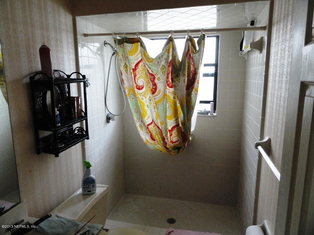 1643 Derringer Road Jacksonville, FL 32225 - Photo 12 of 21 a view of walk in closet with clothes and shoes