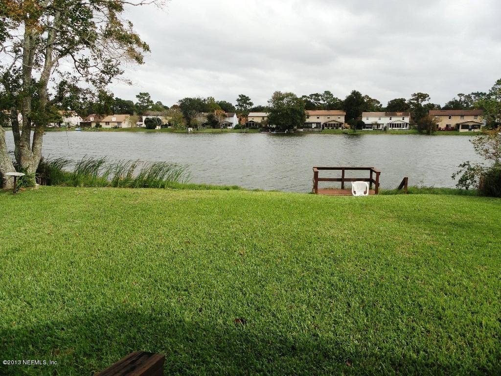 1643 Derringer Road Jacksonville, FL 32225 - Photo 2 of 21 a view of a lake with houses in the back