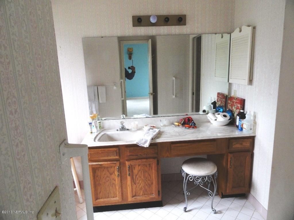 1643 Derringer Road Jacksonville, FL 32225 - Photo 21 of 21 a bathroom with a sink and a mirror