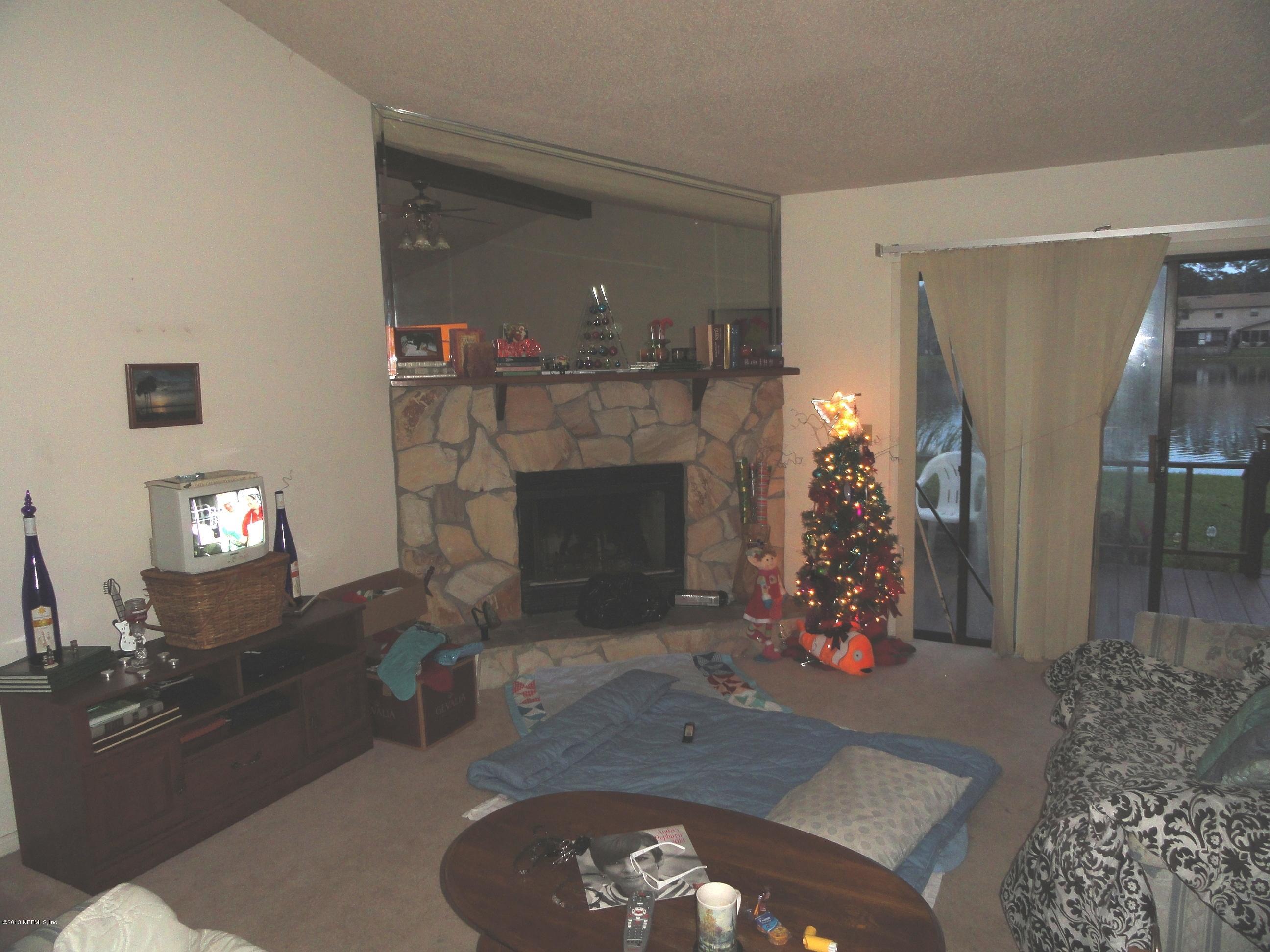 1643 Derringer Road Jacksonville, FL 32225 - Photo 3 of 21 a living room with furniture and a fireplace