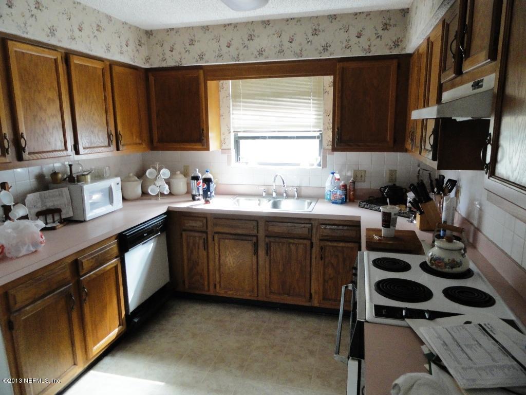 1643 Derringer Road Jacksonville, FL 32225 - Photo 5 of 21 a kitchen with a sink stove and cabinets