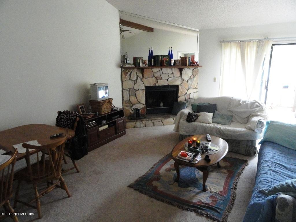 1643 Derringer Road Jacksonville, FL 32225 - Photo 7 of 21 a living room with furniture a fireplace and a table