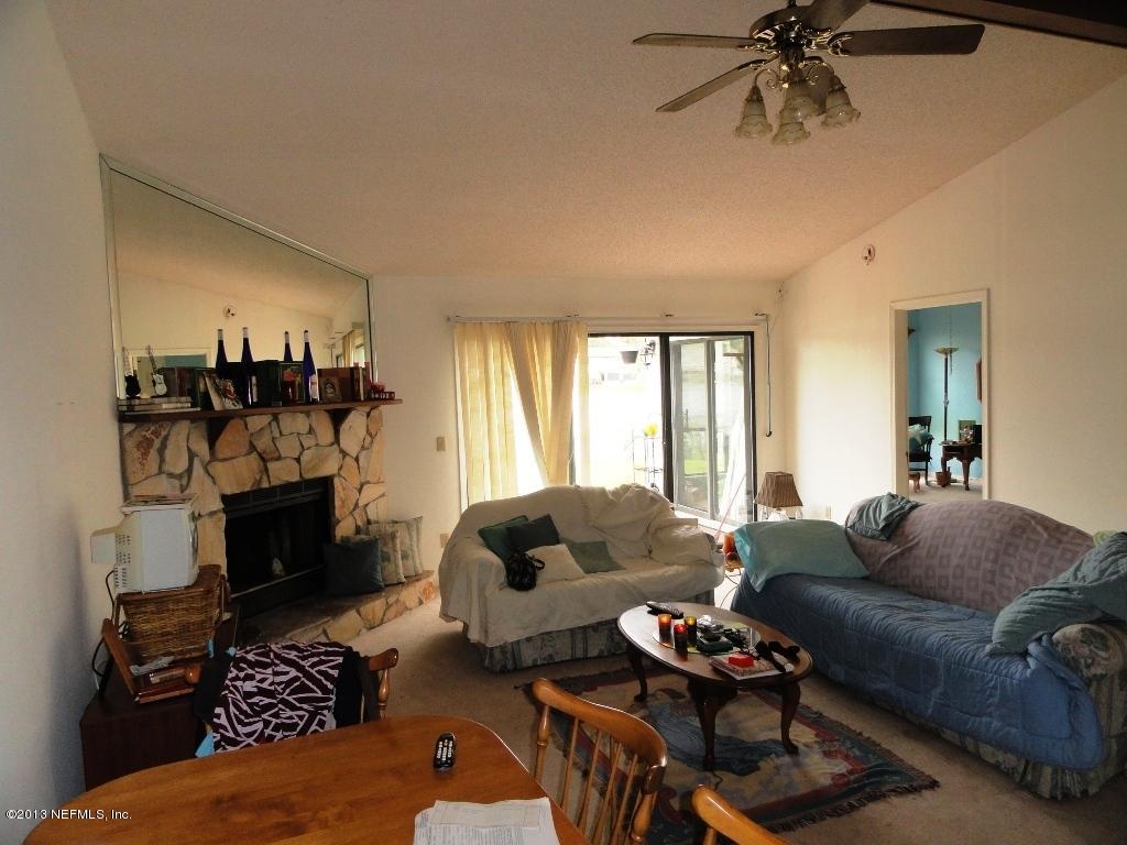 1643 Derringer Road Jacksonville, FL 32225 - Photo 8 of 21 a living room with furniture and a fireplace