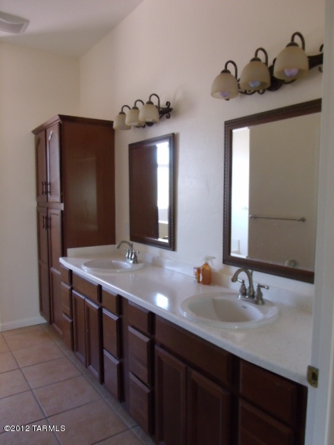 1490 Circulo Jacona Rio Rico, AZ 85648 - Photo 15 of 29 a bathroom with a double vanity sink and a mirror