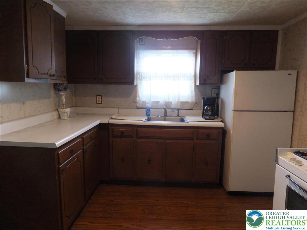 9 North 4th Street Coplay, PA 18037 - Photo 6 of 17 a kitchen with a sink a refrigerator and cabinets
