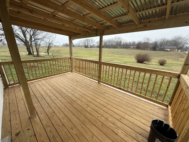 a view of balcony with wooden floor