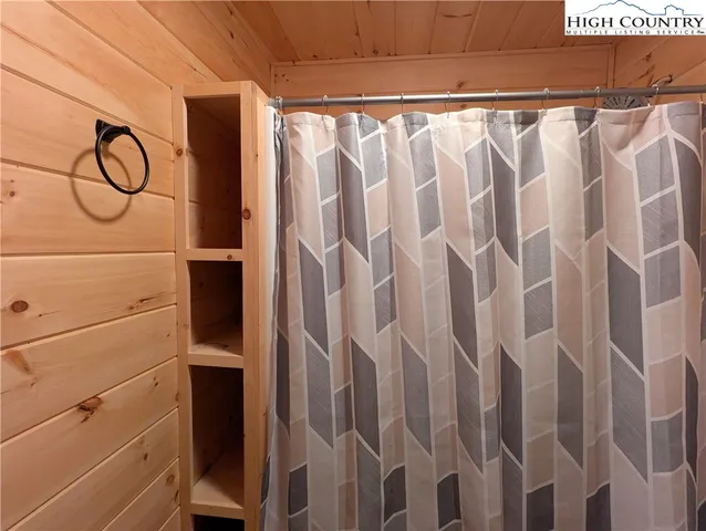 a view of walk in closet with clothes